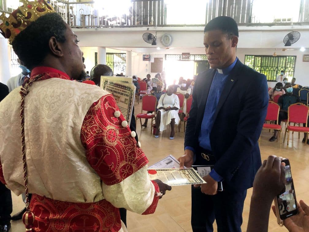 Pastor Emmanuel receiving ordination papers.